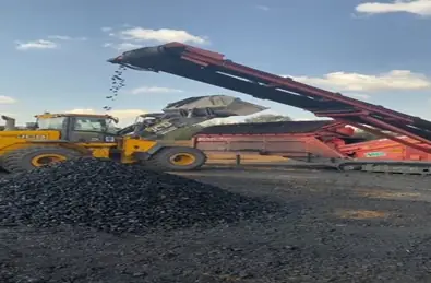 Loader at a conveyor stockpile