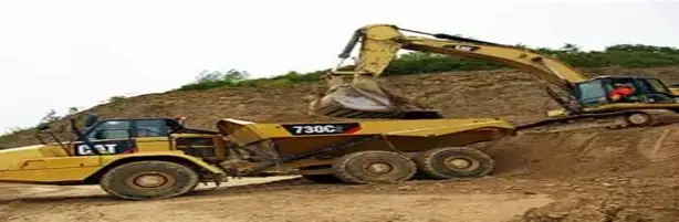 Excavator loading an articulated dump truck